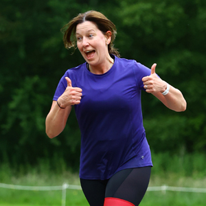 Maria Hall running and giving thumbs up