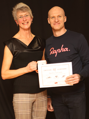 A woman receives a certificate from a man