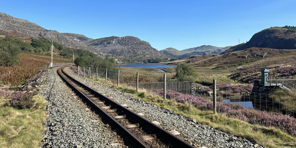 railway tracks alongside a mountain