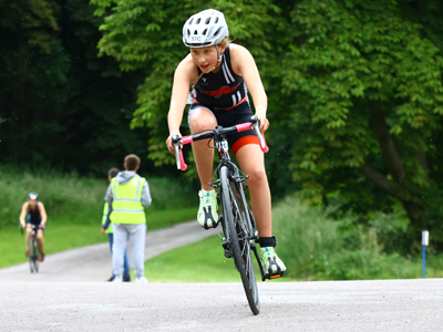 A girl riding a bicycle during a race
